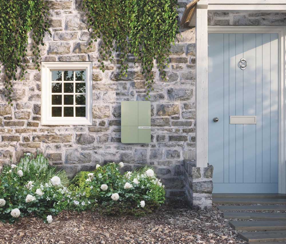 An Andersen charge point mounted on the exterior wall of a cottage